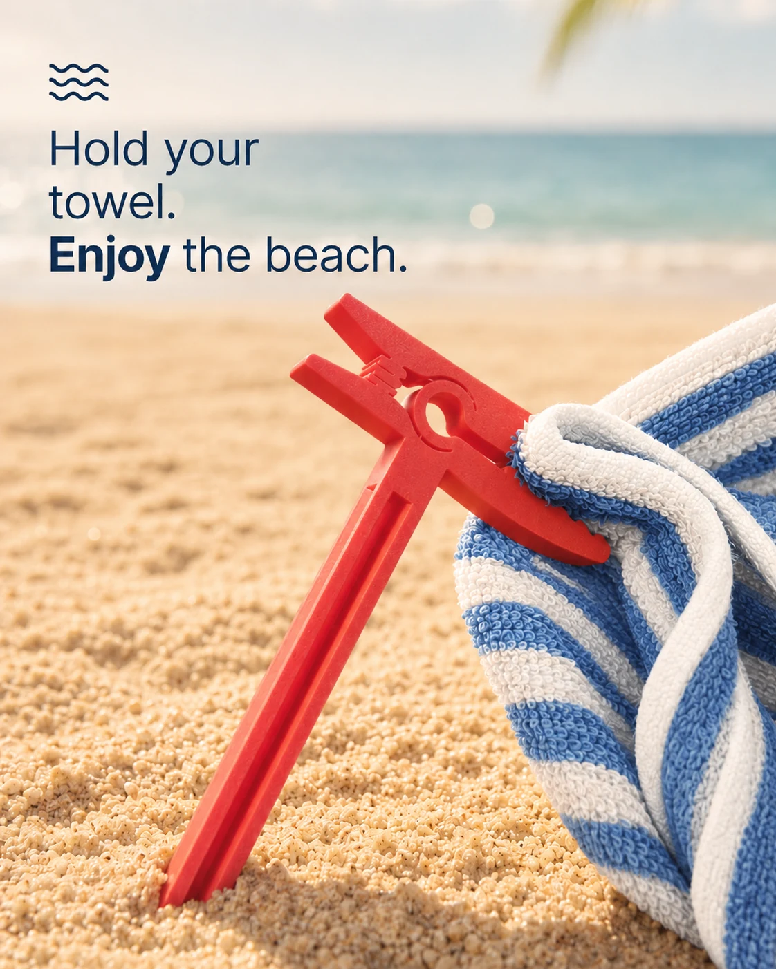 Pink towel clip holding a striped beach towel in the sand