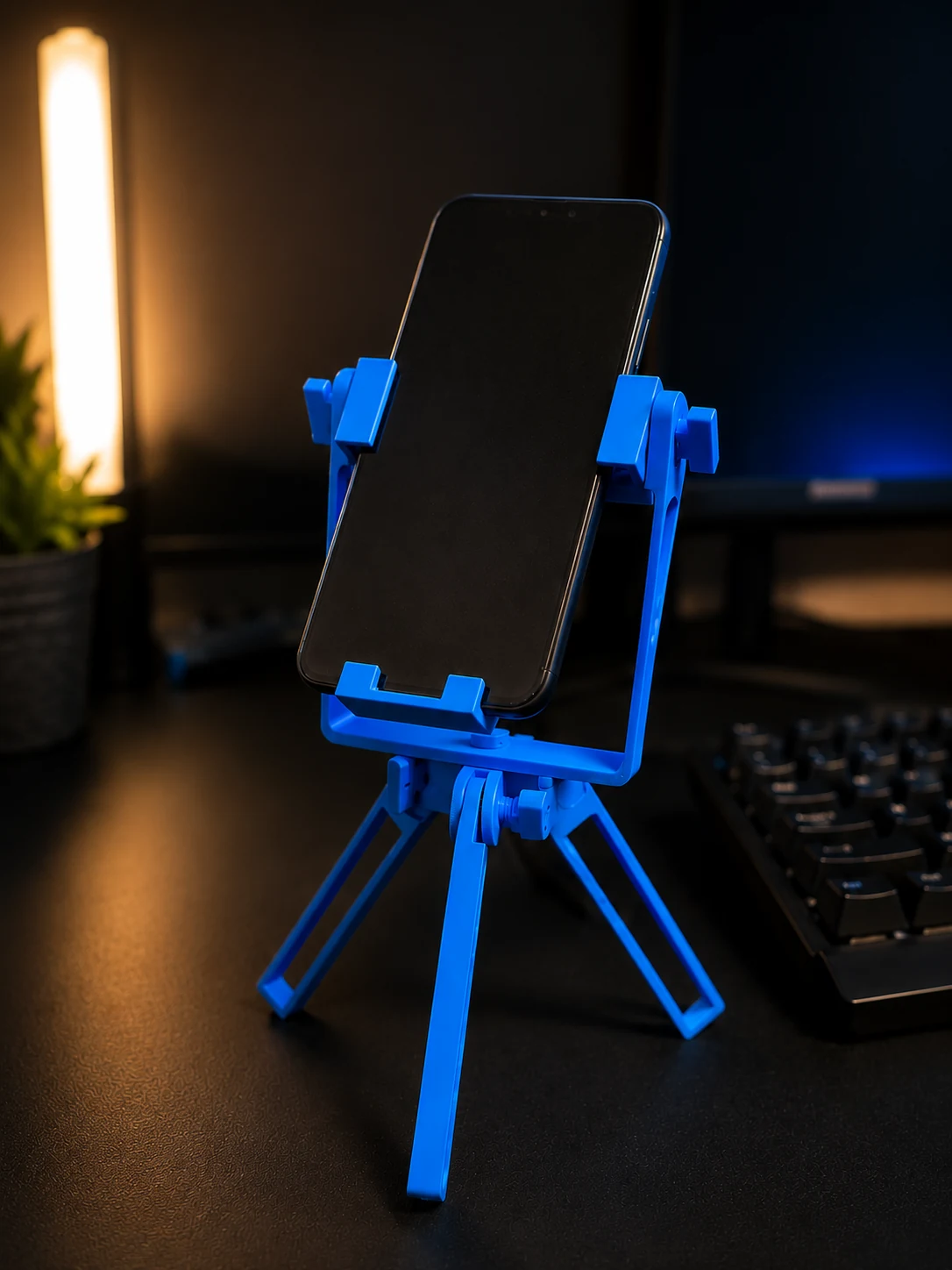 Blue 3D printed Phone Tripod holding a smartphone